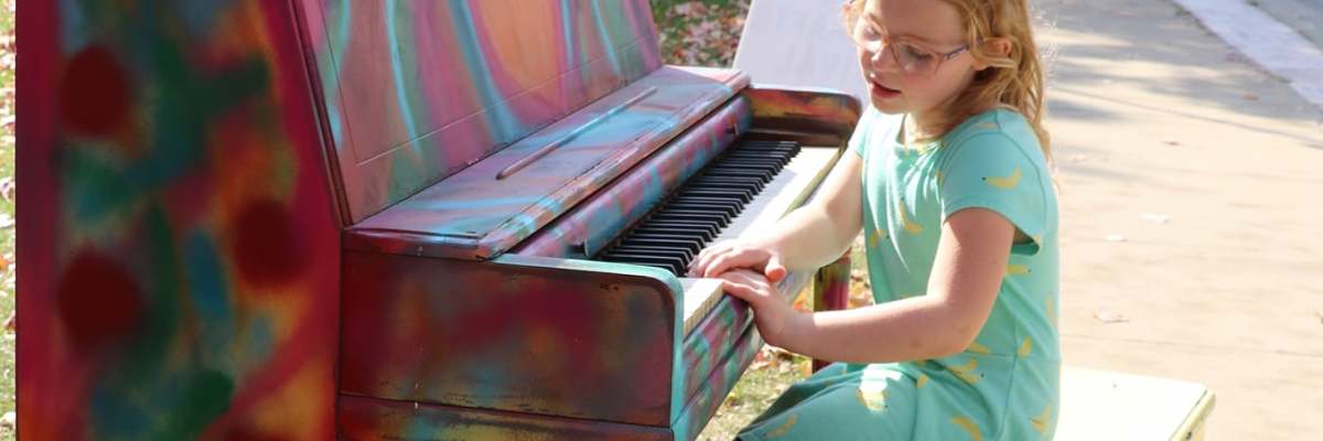 Charlotte playing the piano at the Arts and Crafts Festival in McGregor, IA